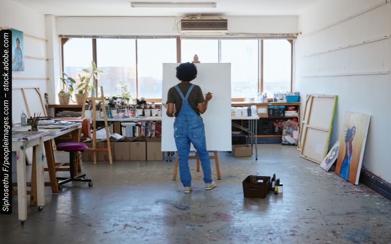 An artist painting in her art studio