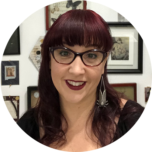 A woman with red hair and glasses